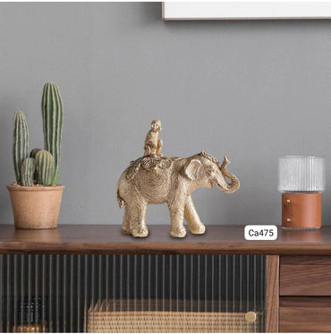 Articulo decorativo elefante dorado con mono sobre el 20,3* 7,7cm* 18,7cm