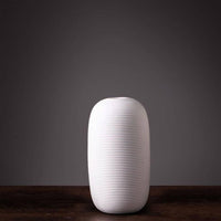 Jarron florero de ceramica blanco en espiral mediano  10cm* 10cm* 20cm