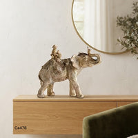 Articulo decorativo elefante dorado con mono y loro sobre el  26cm* 9cm* 21cm
