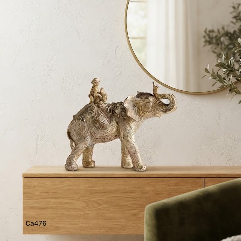 Articulo decorativo elefante dorado con mono y loro sobre el  26cm* 9cm* 21cm