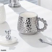 Mugs plateado ceramica detalle oso en tapa manija bolas  430ml