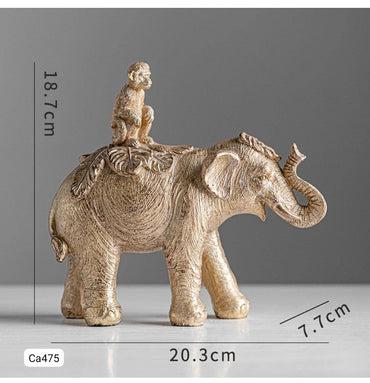 Articulo decorativo elefante dorado con mono sobre el   20,3* 7,7cm* 18,7cm